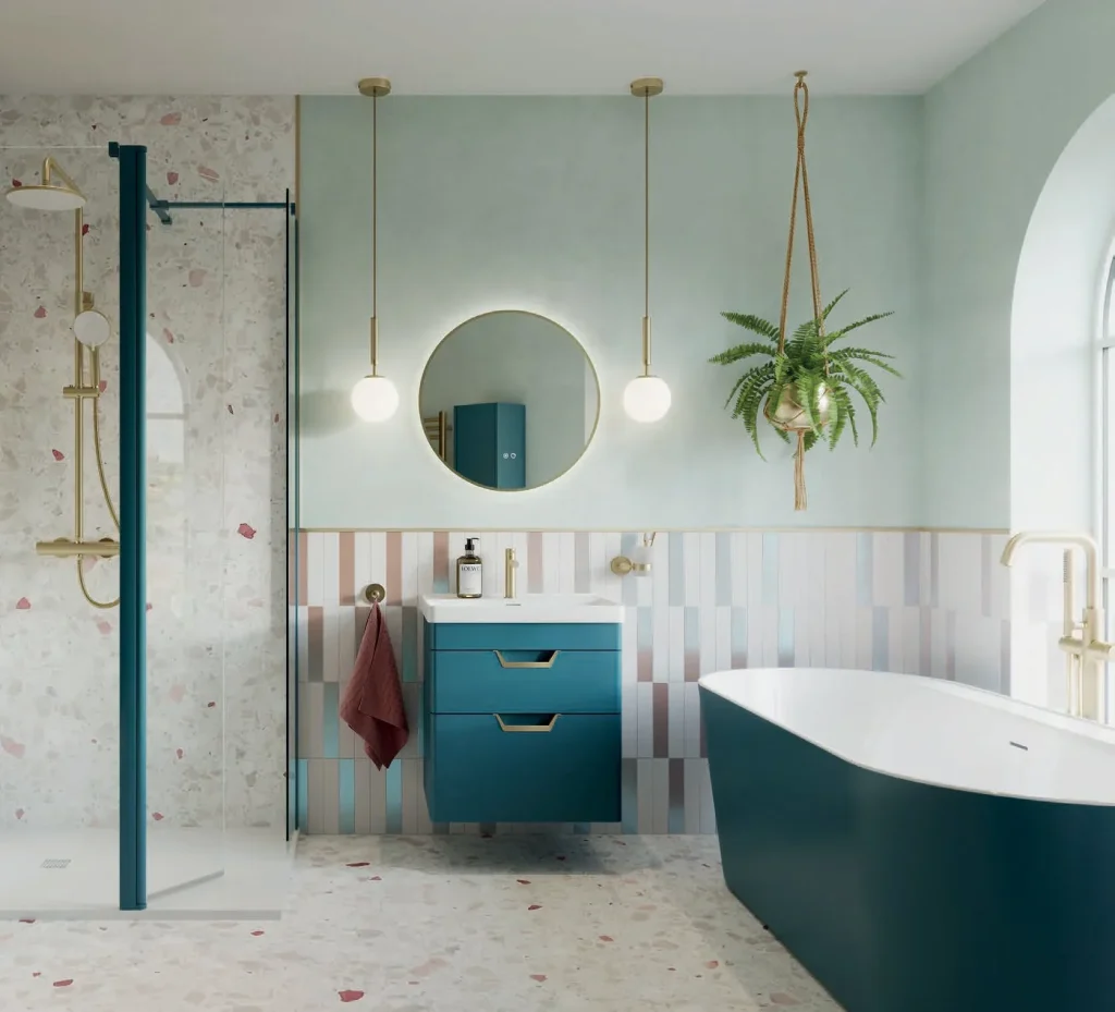 Luxury bathroom renovation in Sydney with teal vanity, freestanding bathtub, terrazzo tiles and gold fixtures